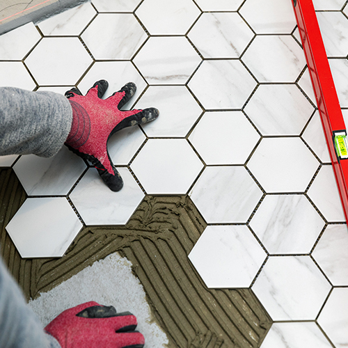 Worker Replacing Shower Tile Floor